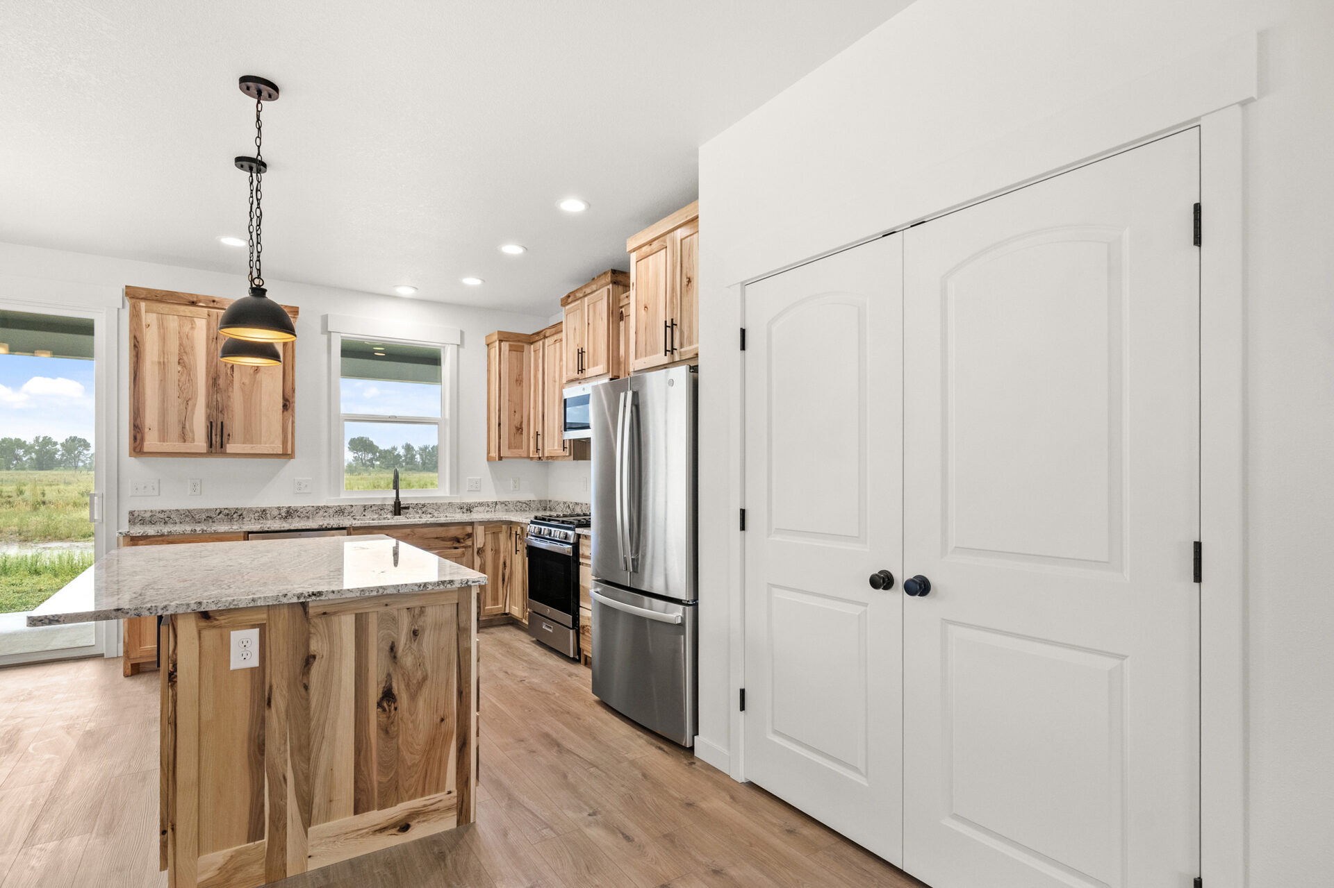 Kitchen with island and refrigerator at 230 Stirling Loop