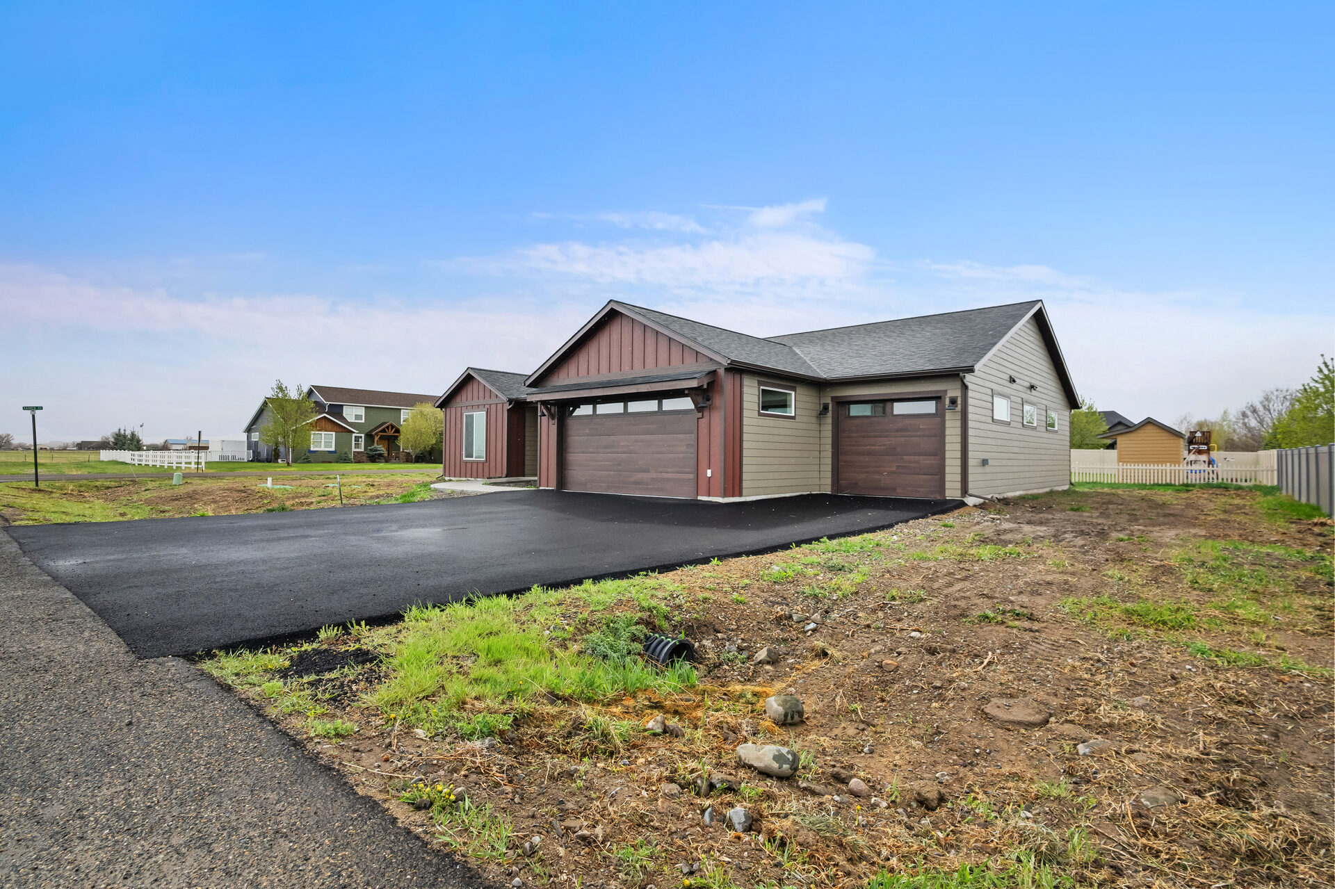 Side exterior and three-car garage at 3814 Lovegrass Ln