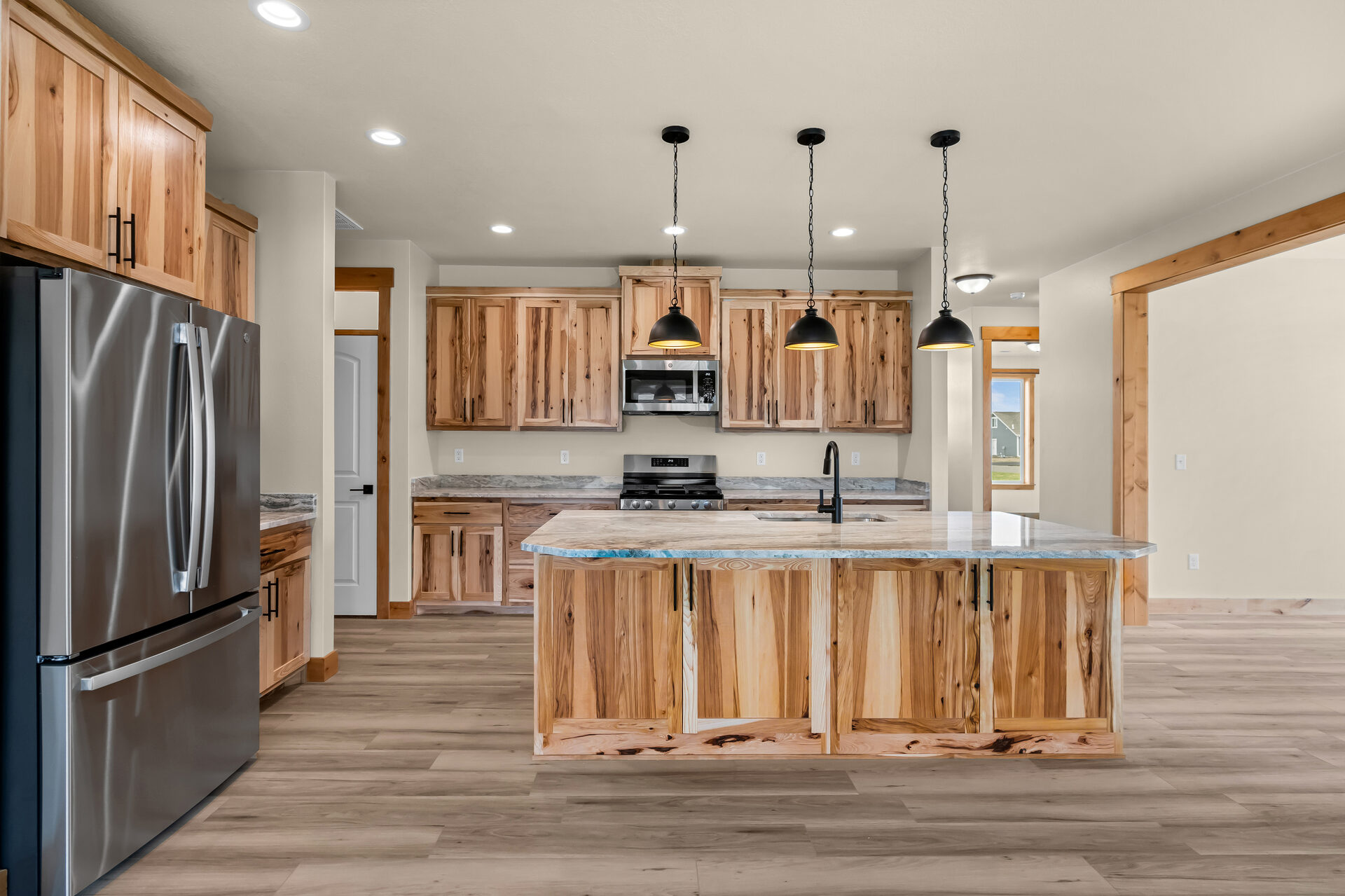 Kitchen island and stainless appliances at 3814 Lovegrass Ln